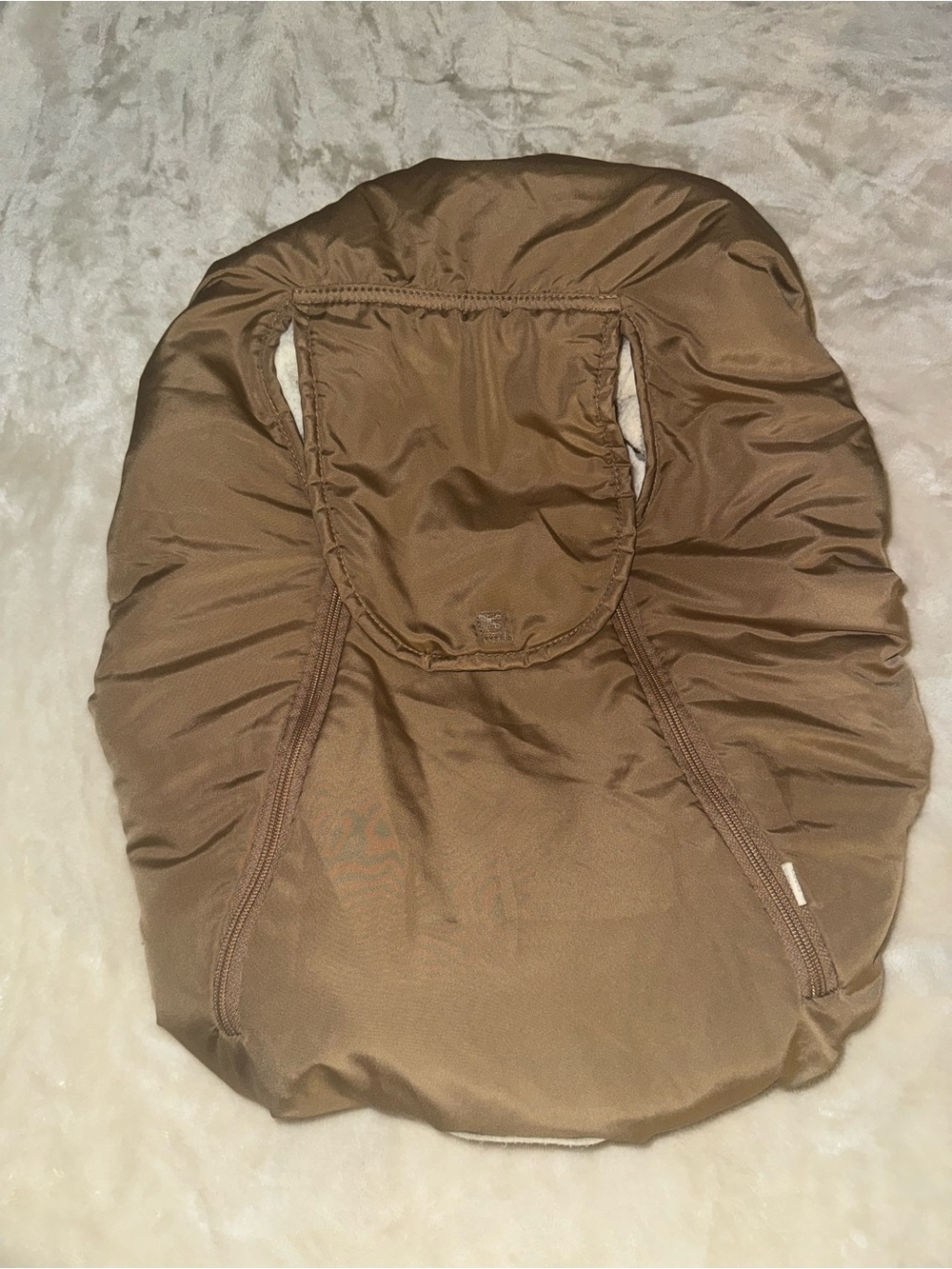 Brown car seat cover with a white fluffy inside